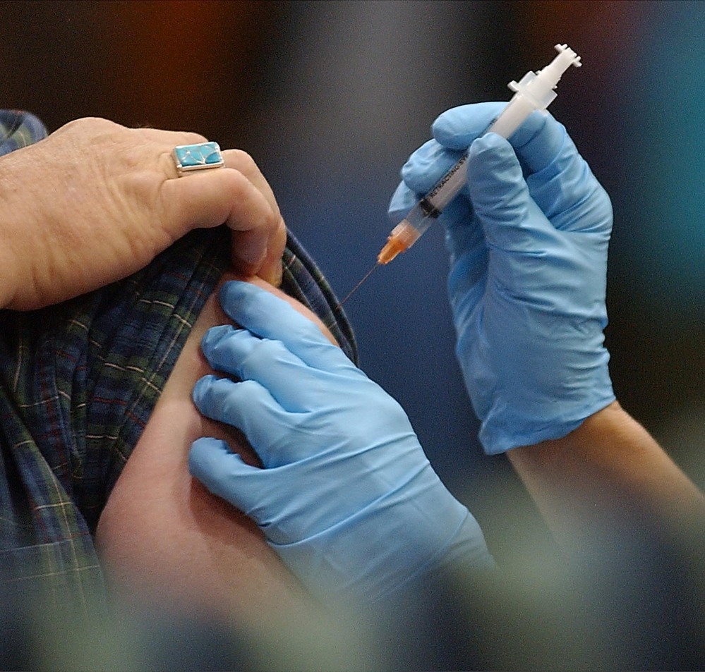 FILE-In this Nov. 18, 2004 file photo, a flu shot is administered in Barre, Vt.  Hospitals serving Vermont are split on making flu shots mandatory for employees, with some hoping voluntary efforts will get them to the federal goal of 90 percent of health workers being immunized. (AP Photo/Toby Talbot, File)