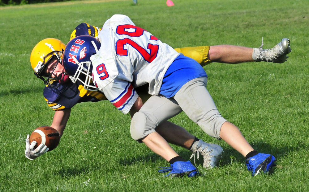 Messalonskee's Josh Goff takes Mt. Blue's Randy Barker down during a scrimmage Monday in Oakland.
