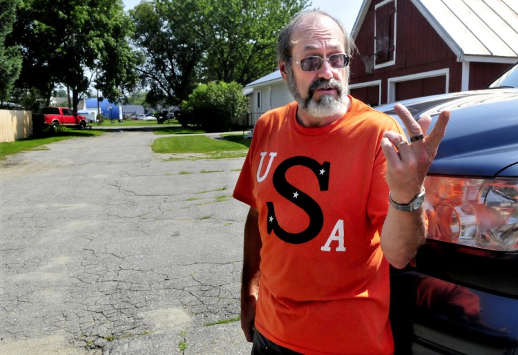 Rick Hunter, with Moody Street stretching out behind him on Tuesday, is one of the street's residents who has joined his neighbors in a legal bid to have the street declared a public way and maintained by the town of Skowhegan.