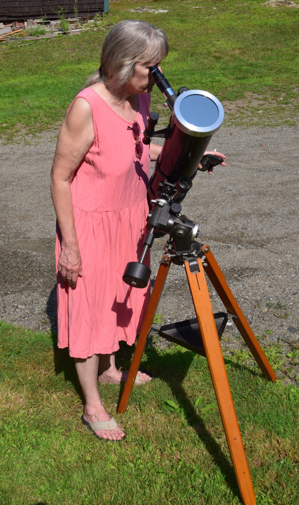 Bonnie Woellner watches the partial solar eclipse Monday afternoon through the Earth-based 4.5-inch Newtonian reflector telescope located in Troy.