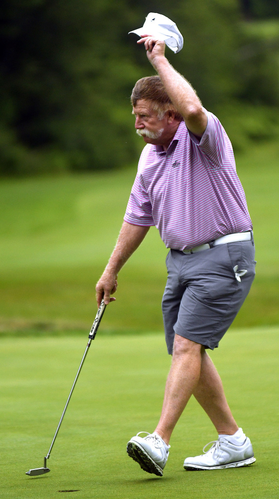 Mark Plummer of Manchester greets a fan after making a putt during the first round of the Charlie's Maine Open last month. Plummer won the Maine Senior Amateur on Wednesday.