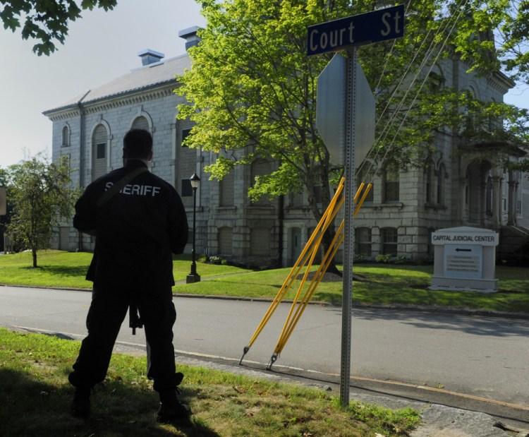 Kennebec County Chief Civil Deputy Harry McKenney stands guard at corner of State and Court streets during a drill Thursday at the Kennebec County Correctional Facility in Augusta.