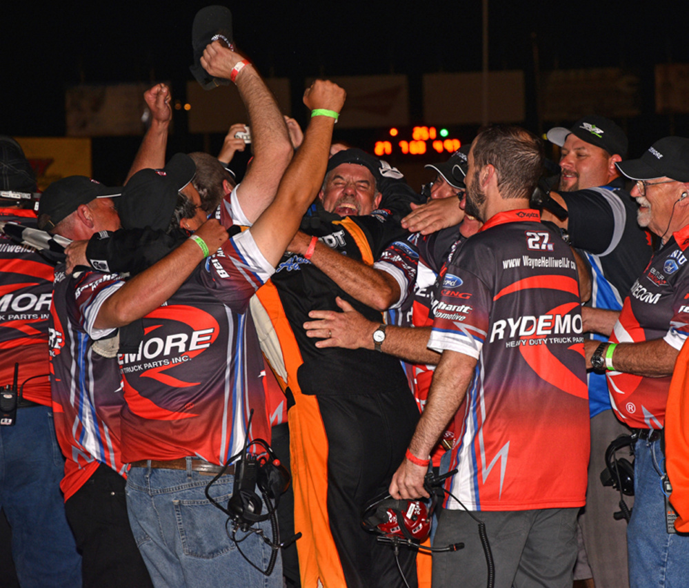 Wayne Helliwell Jr. leaps into the arms of his team after winning the Oxford 250 last August at Oxford Plains Speedway.