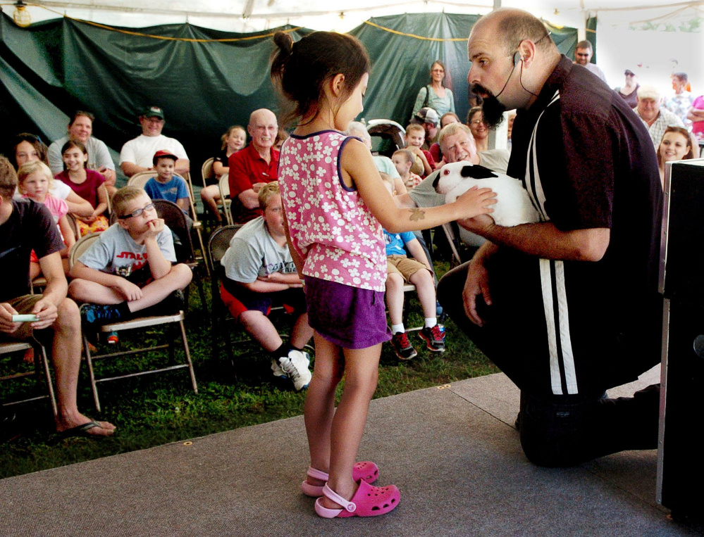 HARMONY,  ME-  September 4: June Noyes pets the live rabbit that magician Conjuring Carroll pulled  out of a box after June used a magic wand during a magic show at the Harmony Free Fair on Sunday, September 4, 2016.  (Photo by David Leaming/Staff Photographer)