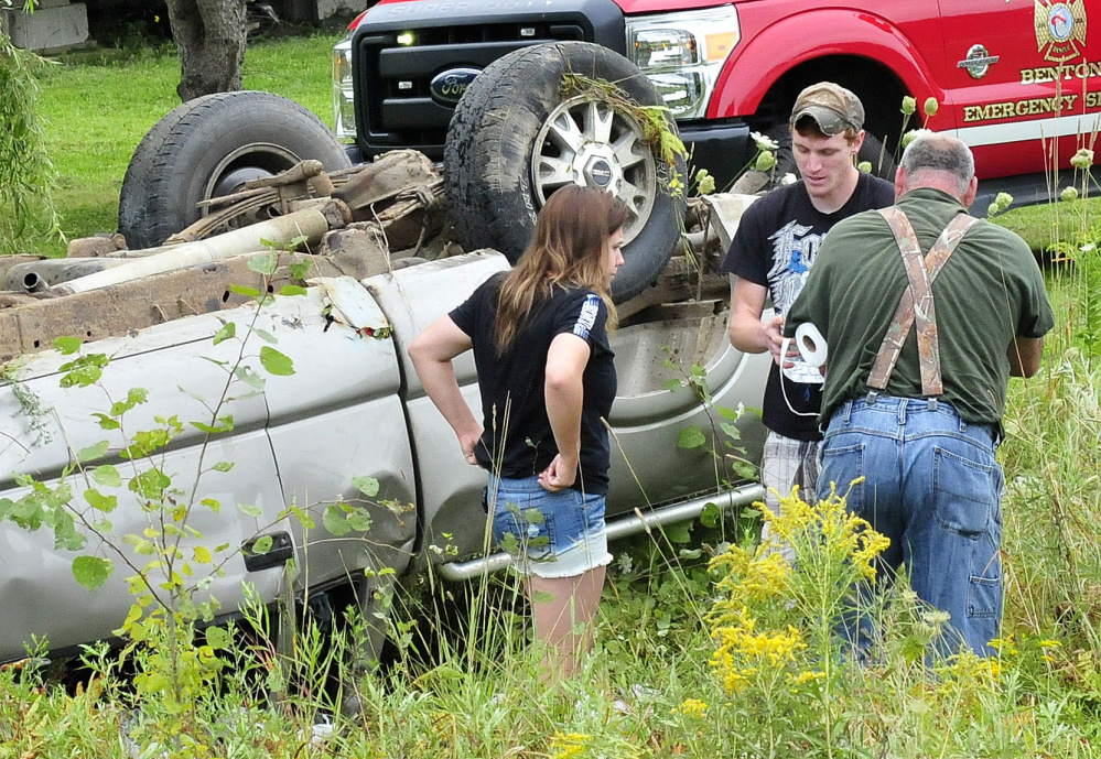 Benton homeowners Lisa Jordan and Dylan Ellis, center, and another man were first on the scene where a vehicle went off the Albion Road in Benton with two occupants who were injured on Tuesday.