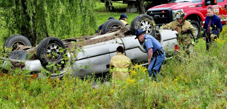 State Police and Fairfield firefighters arrive to assist injured occupants of a vehicle that lost control and went off the Albion Road in Benton on Tuesday.