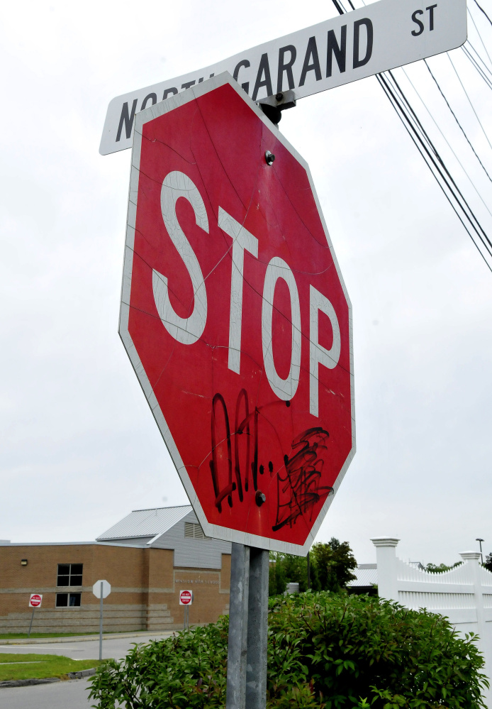 Graffiti mars a stop sign Wednesday at the end of North Garand Street near Winslow High School.
