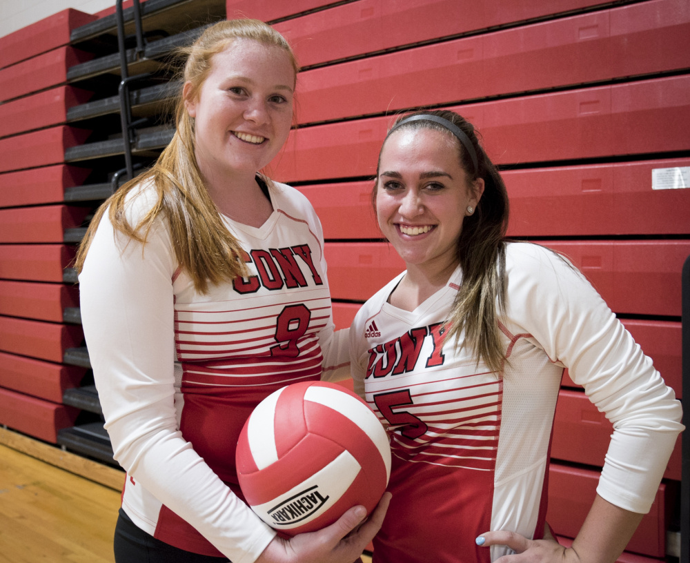 Cony volleyball players Lauren Coniff, left, and Sarah Caron pose before a scrimmage Monday night against Brewer in Augusta. Coniff and Caron have played for a Portland-area travel team each of the past two winters