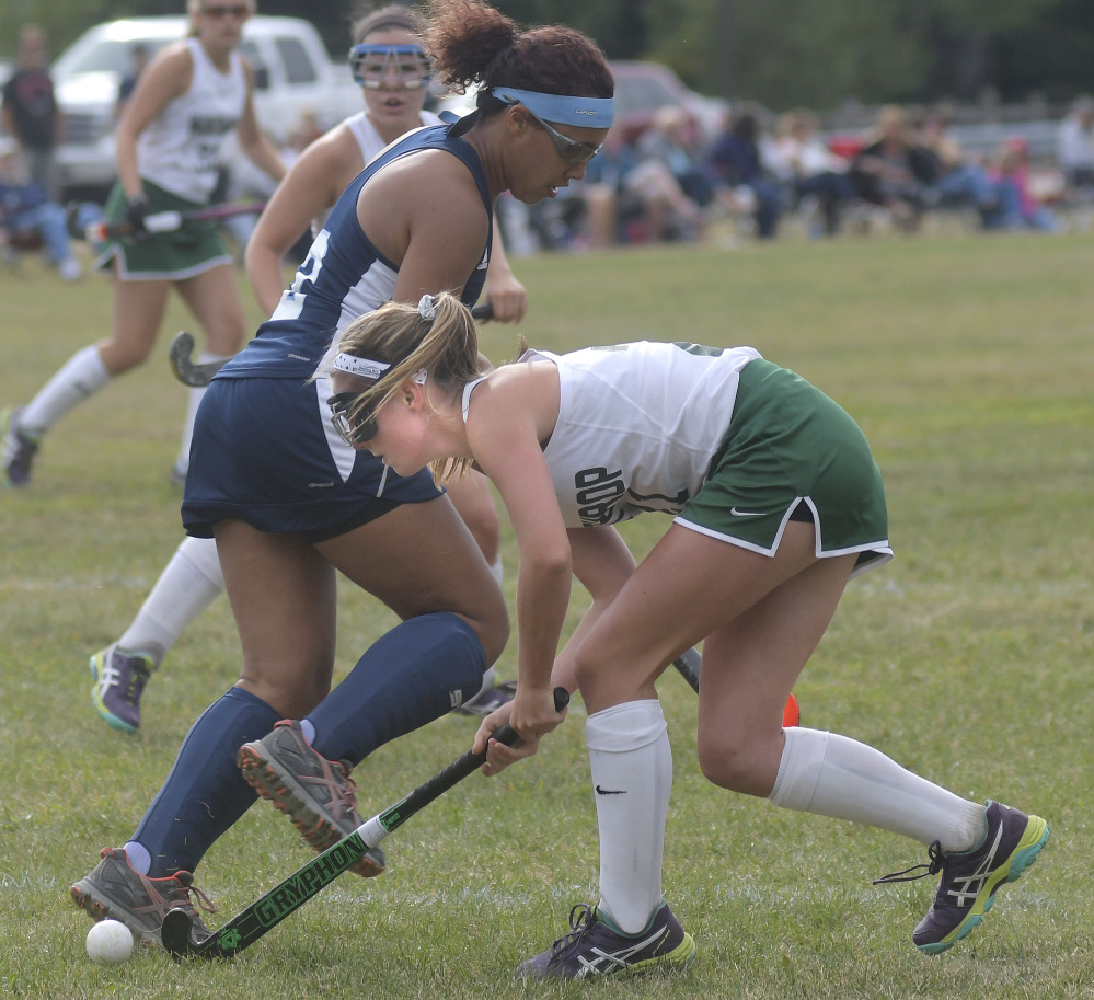 Winthrop's Katie Perkins, right, drives past Dirigo defender Grace Timberlake during a field hockey game Wednesday in Winthrop. The Ramblers won, 2-1.