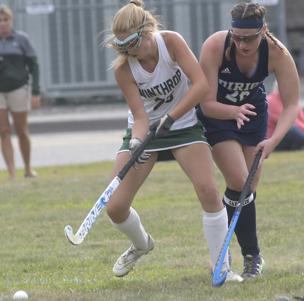 Winthrop High School's Bry Baxter, left, collides with Dirigo defender Ashley Walker during a field hockey game Wednesday in Winthrop.