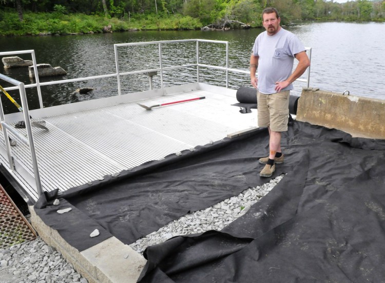 Mike Joslyn, of Messalonskee Stream Hydro, who helped build a fishing platform at the outlet of Messalonskee Lake in Oakland that meets the standards of the Americans with Disabilities Act, explains Thursday that access will be paved from a designated parking spot to the platform.