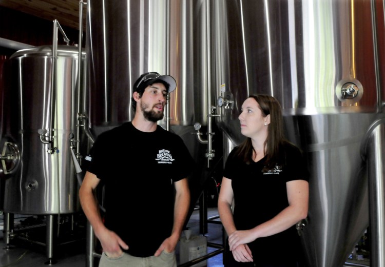 On Thursday, Bigelow Brewing Co. assistant brewer Colin Hoffman and employee Jordan Powers serve up a sample of La Saison du Labrador beer, which was brewed for the Skowhegan Craft Brew Festival this Saturday.
