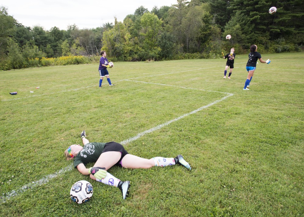 Ally Drew, a goalie for Waterville, stretches before working through drills at a preseason practice at Runnels Field in Waterville on Aug., 15.