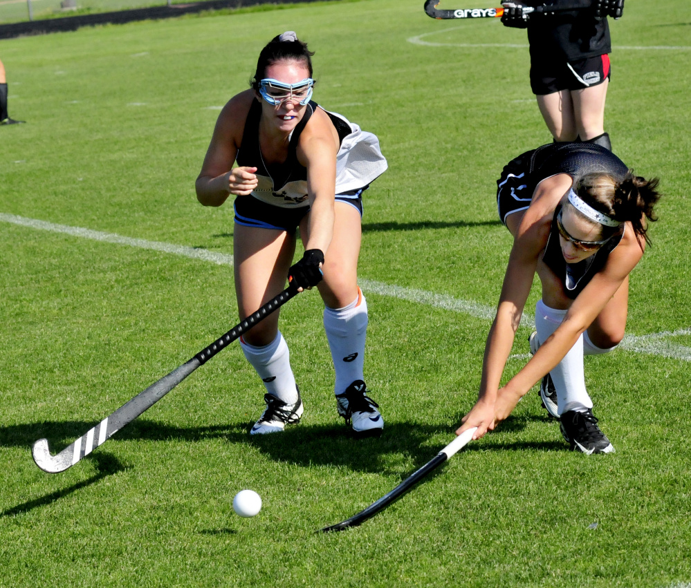 Skowhegan field hockey players Maliea Kelso, left, and Hannah McKenney compete during an Aug. 24 practice in Skowhegan.