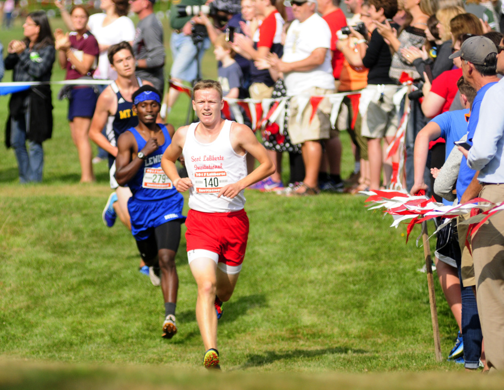 Cony's Caleb Richardson runs past fans in the last mile of the annual Scot Laliberte Invitational on Aug. 25 at Cony High School in Augusta.