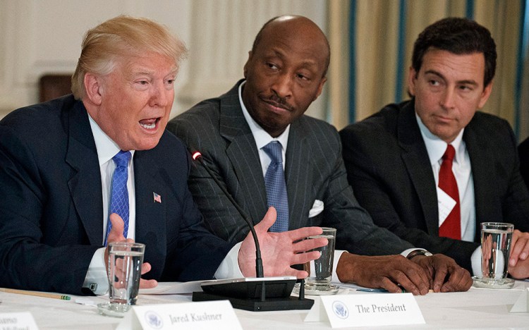 Merck CEO Kenneth Frazier, center, listens to President Trump during a meeting with manufacturing executives at the White House on Feb. 23, 2017. Then-Ford CEO Mark Fields is at right. 