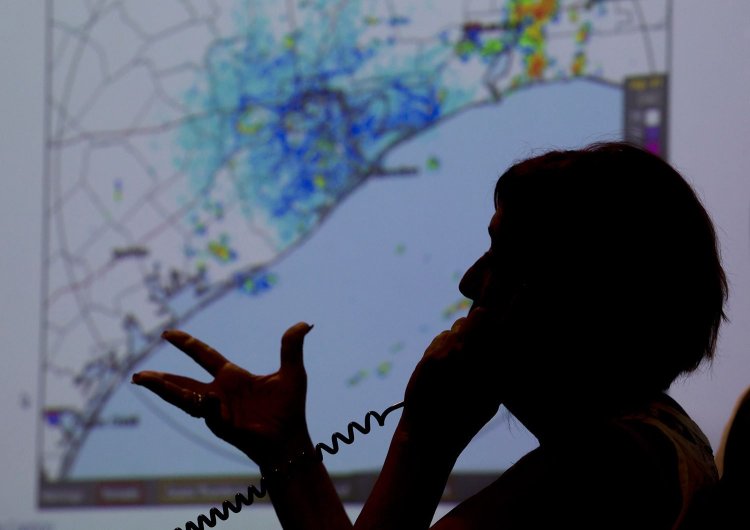 A map of the Texas coast is projected on a screen Thursday as Deb Nowinski, a disability integration coordinator  in the Galveston County Office of Emergency Management, gives information to a caller regarding the approach of Hurricane Harvey.