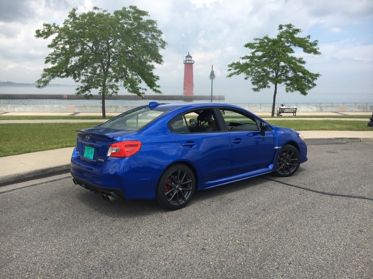 The 2018 Subaru WRX in premium trim and pearl blue paint is a better entry-level sports car than a highway cruiser. 