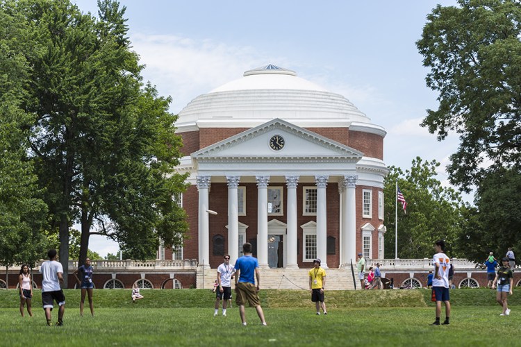 Students play Frisbee on the green in front of the Thomas-Jefferson-designed Rotunda at the University of Virginia on June 26, 2017. 