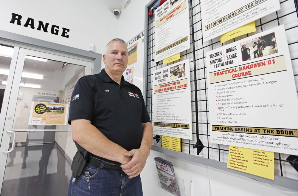 Bill Keith stands by a board with practical handgun course information. Bill Keith is a shooting instructor at Windham Indoor Shooting Range. Staff photo by Jill Brady