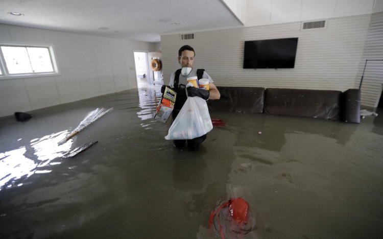 Gaston Kirby walks through floodwater still in his home in Houston on Monday, 10 days after Harvey hit.
