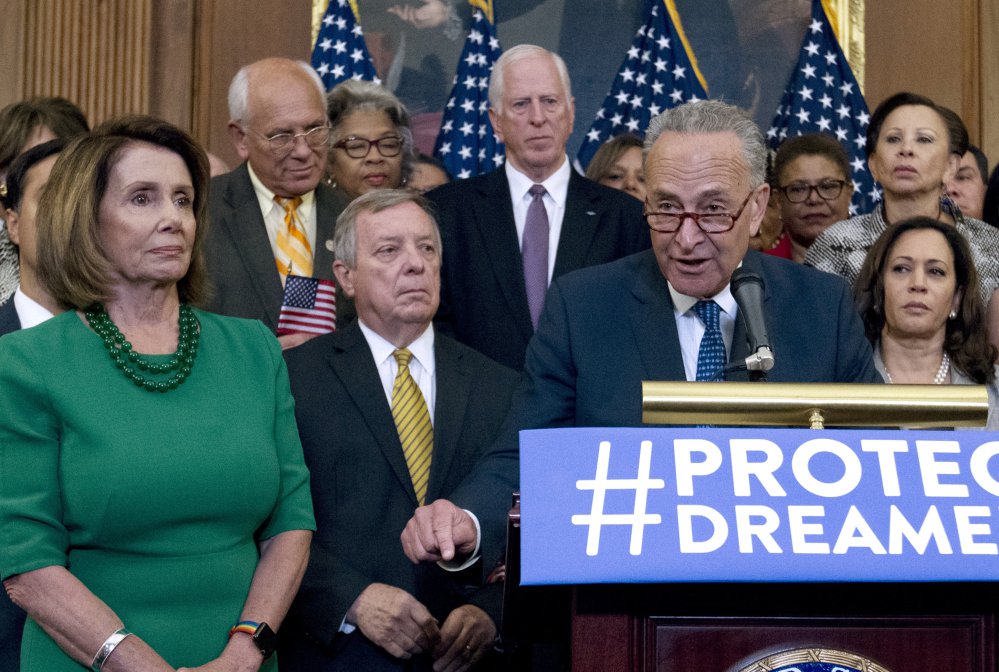 Senate Minority Leader Chuck Schumer of New York and House Minority Leader Nancy Pelosi of California appear with Democrats on Sept. 6 in Washington. President Trump's alliance with Democrats has Republicans baffled.