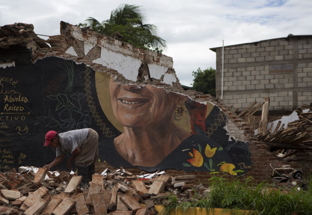 A man recovers bricks Sunday from a building destroyed in Thursday's magnitude 8.1 earthquake in Union Hidalgo, Mexico, a town of about 20,000 people.