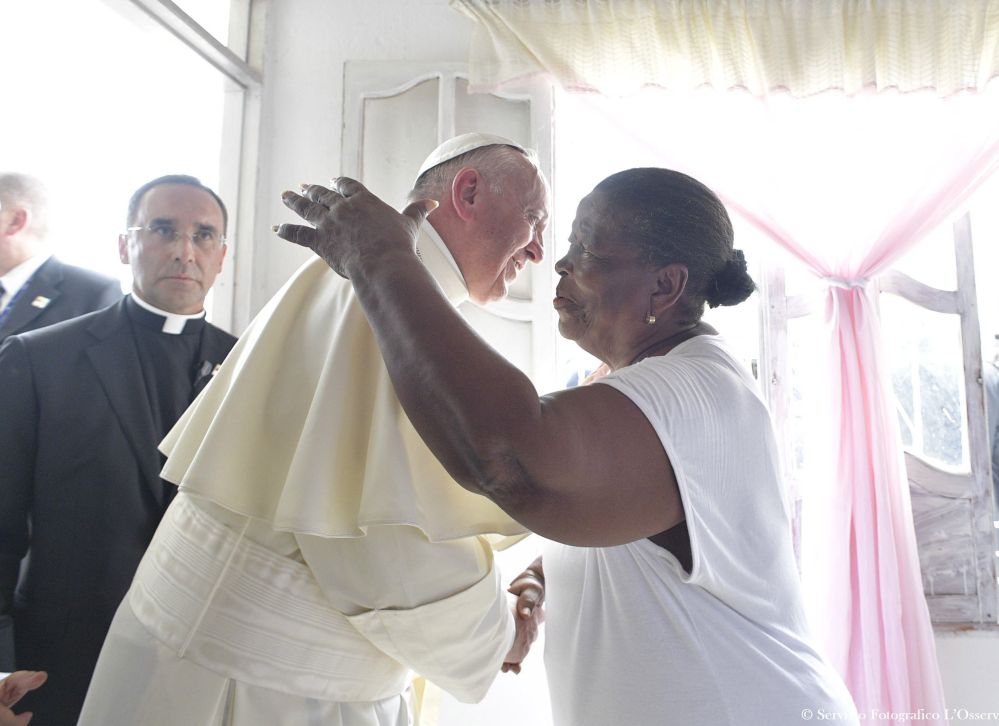 Lorenza Perez greets Pope Francis as he visits her home Sunday in Cartagena on the last day of his trip to Colombia.