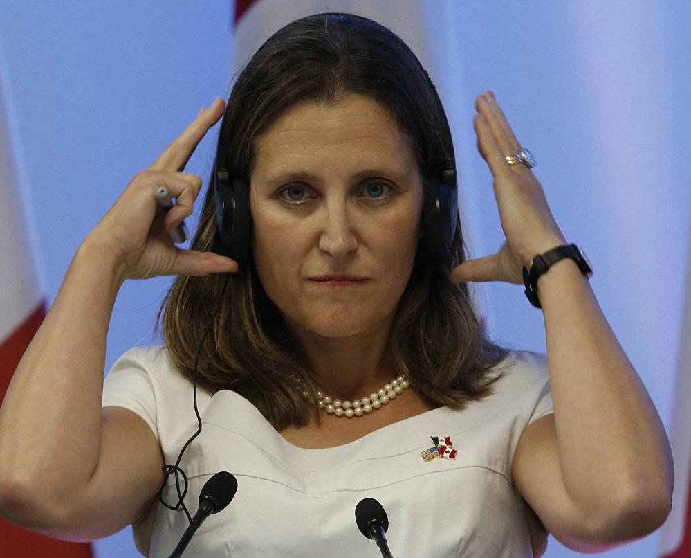 Chrystia Freeland adjusts her headphones during a news conference at NAFTA talks. She's guiding Canada's work on the trade deal and met with labor leaders before talks began.