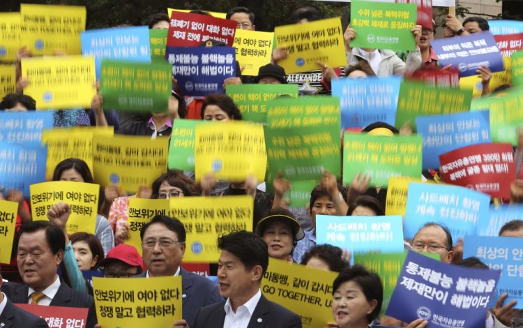 Members of the Korea Freedom Federation shout slogans during a rally to denounce North Korea's latest nuclear test in Seoul, South Korea, on Monday. North Korea threatened to make the U.S. pay a heavy price in retaliation for tough new sanctions on Pyongyang.