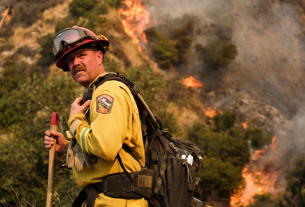 A crew member with the California Department of Forestry and Fire Protection battles a brush fire on a hillside in Burbank, Calif., earlier this month.