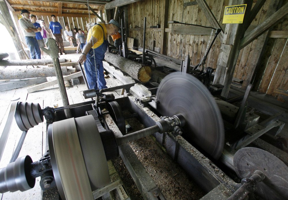 David Newhall operates the saw at the Robinson Sawmill in Calais, Vt.