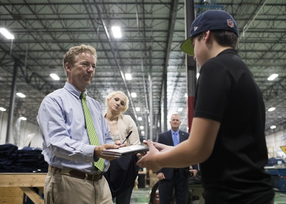 Sen. Rand Paul, R-Ky., left, gives an autograph for Sam Brown, 14, during a meet and greet on Friday. "Republicans gave up on caring about deficits long ago," Paul says.