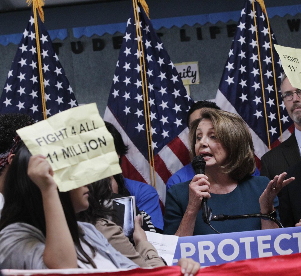 House Minority Leader Nancy Pelosi tries to talk as protesters demonstrate during a press conference on the immigration on Monday in San Francisco, Calif.