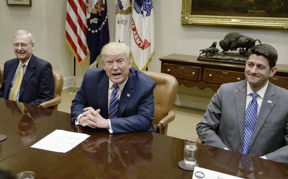 President Trump meets with Senate Majority Leader Mitch McConnell, left, and House Speaker Paul Ryan in June. Competing interests make agreement on a tax overhaul plan difficult, but Republicans are feeling pressure to get a bill to Congress.