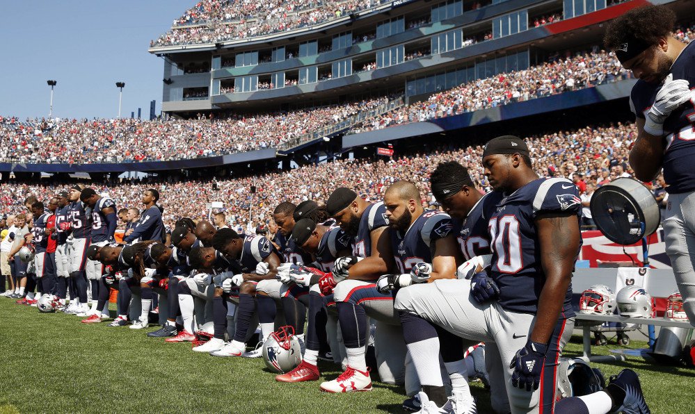 Several New England Patriots players kneel during the national anthem before an NFL game against the Houston Texans on Sept. 24 in Foxborough, Mass.