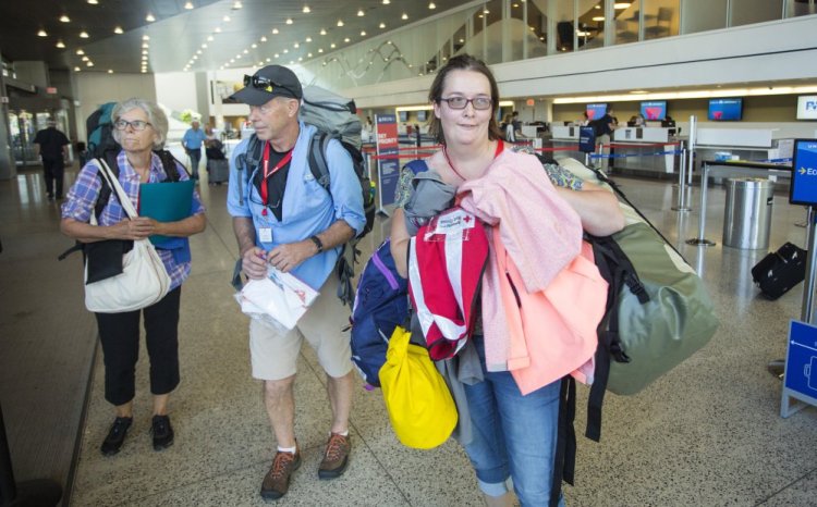 Red Cross volunteers Anne Heminway of Phippsburg, left, Jim Kerrigan of Old Orchard Beach and Crystal Abbott of Alfred arrive at the Portland International Jetport on Monday before flying to Atlanta ahead of their deployment to Puerto Rico.