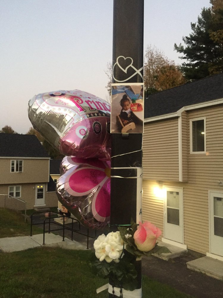 Neighbors, family members and members of the community built a memorial to 17-month-old Tiannah Sevey just outside her home in Lewiston on Sunday.