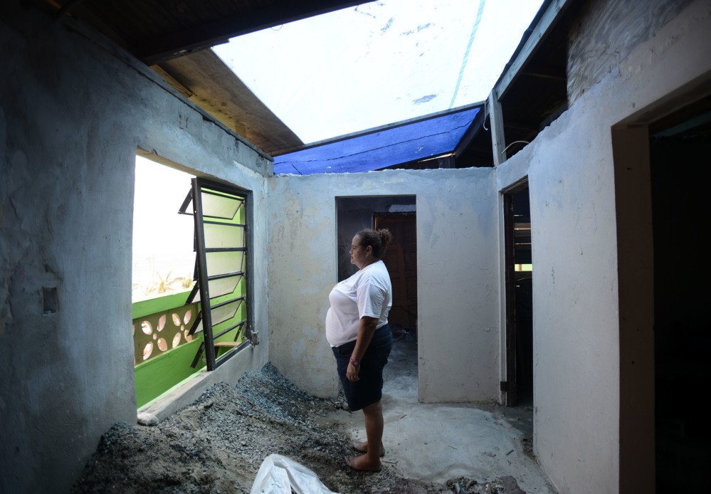 La Perla, Puerto Rico, resident Maritza Rosado stands inside her roofless home Monday. The island territory is reeling in the devastating wake of Hurricane Maria.