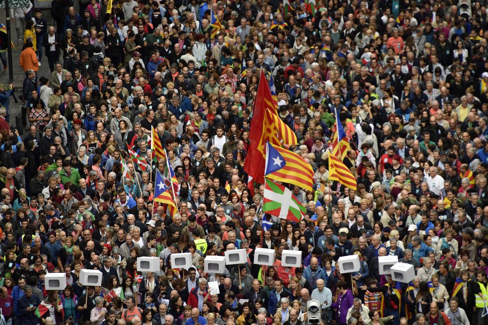 Pro-independence supporters carrying mock ballot boxes and Catalan flags, center top, with Basque flags, center bottom, rally in support of Catalonia's secession referendum in Bilbao, northern Spain, on Saturday. Catalonia's planned referendum on secession is due to be held Sunday by the pro-independence Catalan government, but Spain's government calls the vote illegal because it violates the constitution, and the country's Constitutional Court has ordered it suspended.