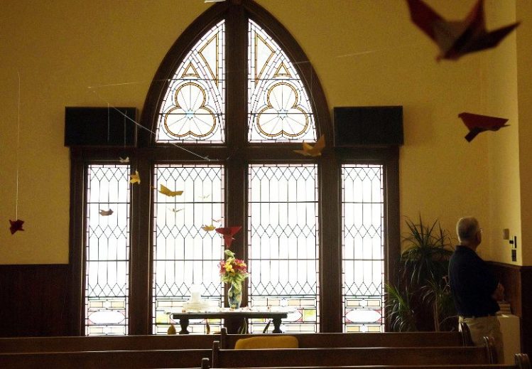 Stained glass windows greet visitors to the chapel of the Winthrop Congregational Church on Wednesday.