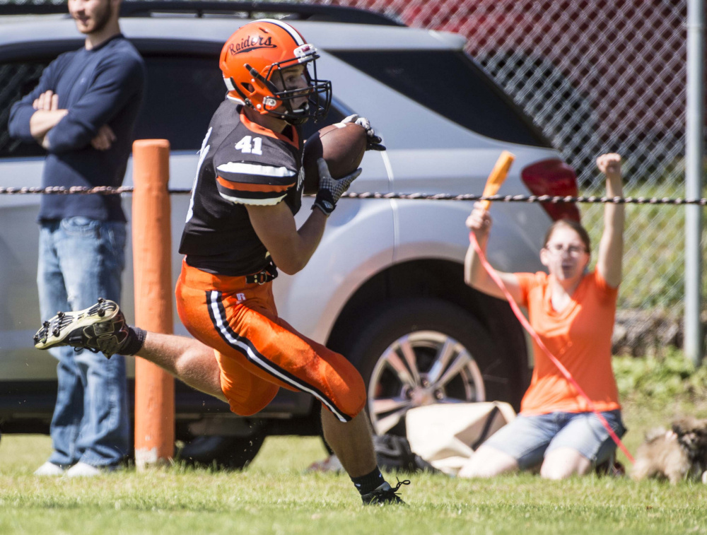 Winslow High School's Benjamin Dorval scores a touchdown in the first quarter against mount Desert Island at Poulin Field in Winslow last Saturday.