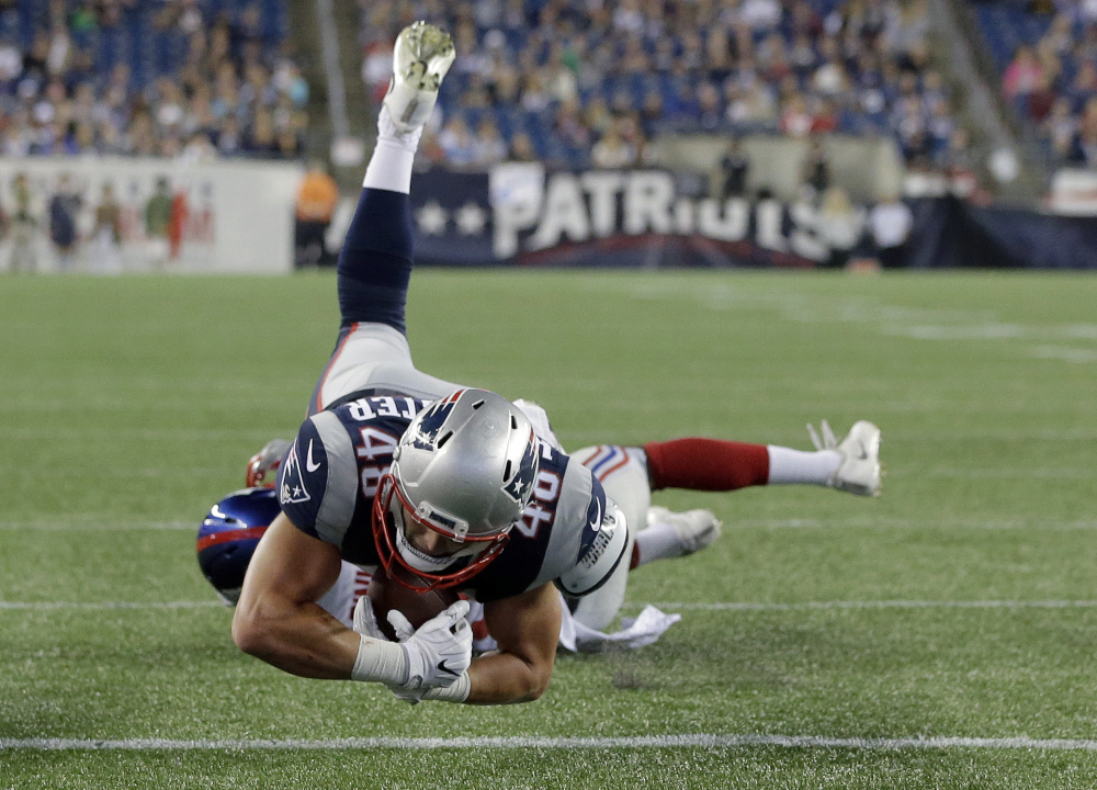 New England Patriots tight end Jacob Hollister dives over the goal line for a touchdown against the New York Giants during the second half of an AUg. 31 preseason game in Foxborough, Massachusetts.