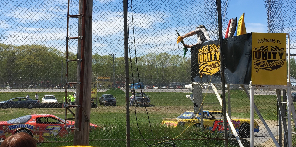 Cars race under the flagstand during a qualifying race on opening day in May at Unity Raceway in Unity. With track owner George Fernald battling health problems, this weekend's racing has been canceled.