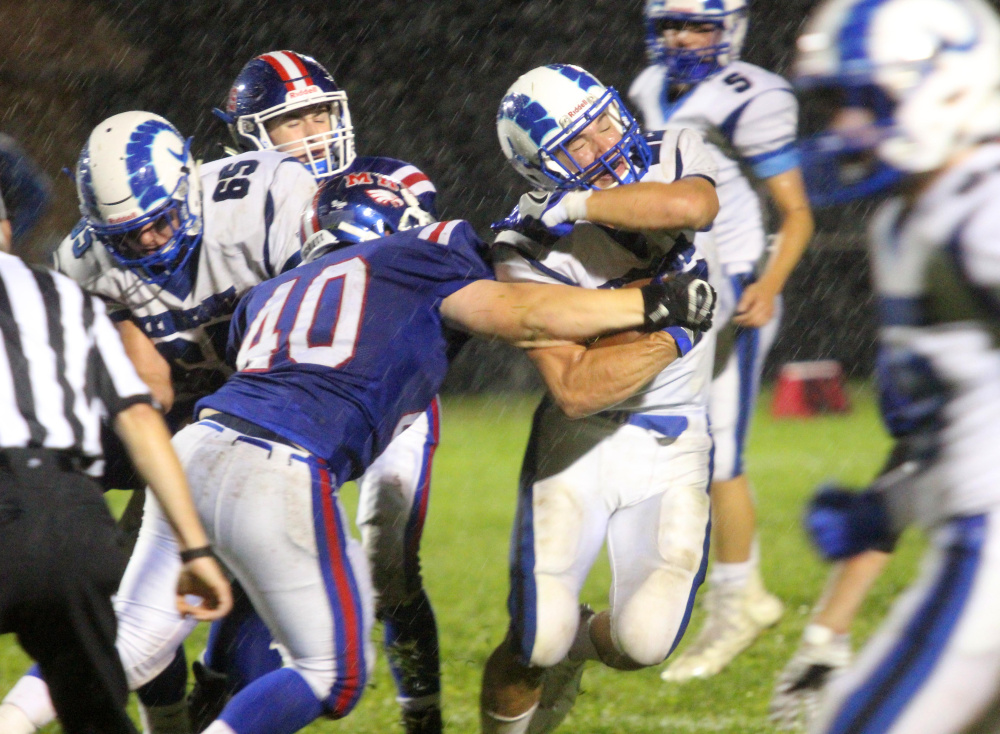 Messalonskee defender Colton Chavarie tries to strip the ball from Kennebunk's Jake Littlefield during first-half action in Oakland on Friday night.