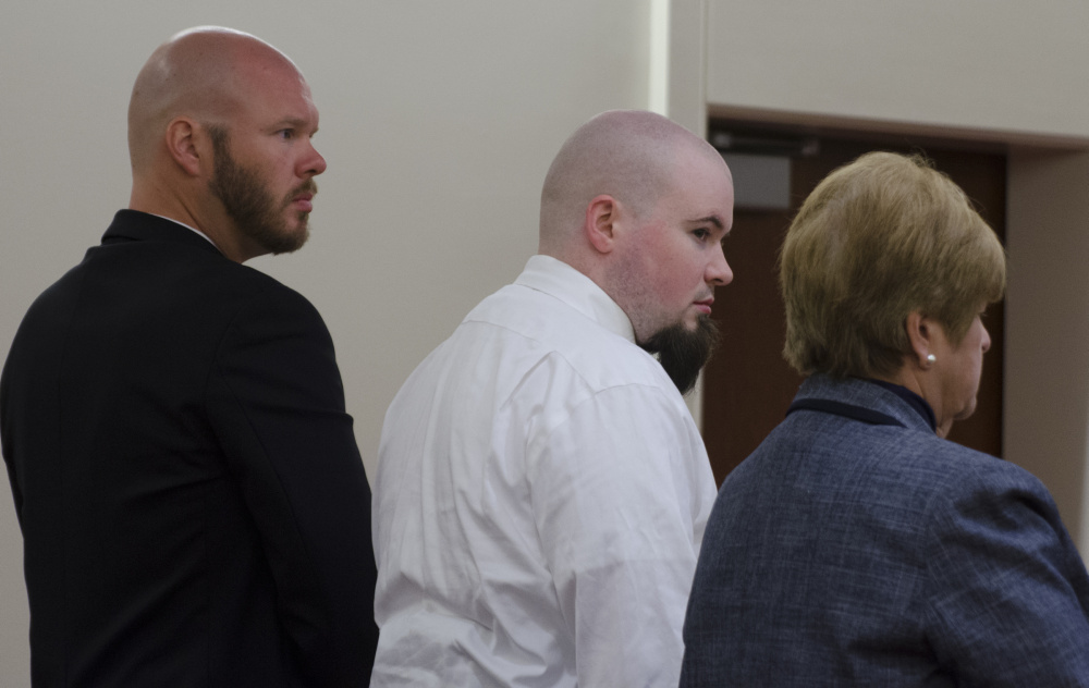 Leroy Smith III, center, stands Monday with his attorneys, Scott Hess, left, and Pamela Ames right, after he entered a plea of guilty, but not criminally responsible, to manslaughter in the death of his father.