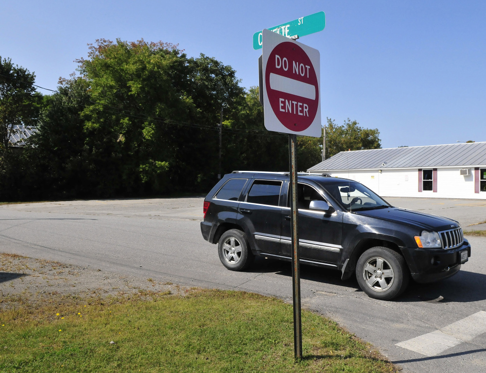 A vehicle pulls out from the one-way Cowette Street on to North Street in Skowhegan on Monday.