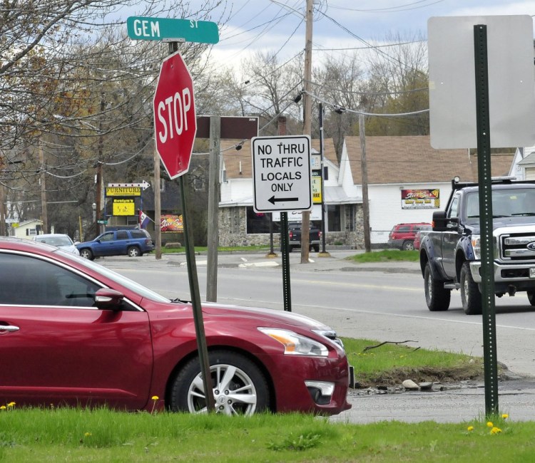 A motorist comes to a stop at the intersection of Gem Street and North Avenue in Skowhegan recently. A new sign tells drivers the roadway is closed to thru traffic but open for local residents on Gem Street. A public hearing at the Board of Selectmen's meeting Tuesday will focus on traffic problems in Skowhegan.