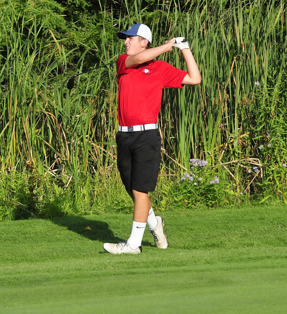 Cony's Jake Whitney watches a shot during a Kennebec Valley Athletic Conference match against Messalonskee on Monday at Belgrade Lakes Golf Course.