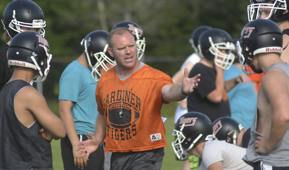 Gardiner football coach Joe White talks to his team during the first day of fall sports practice Aug. 14 in Gardiner.